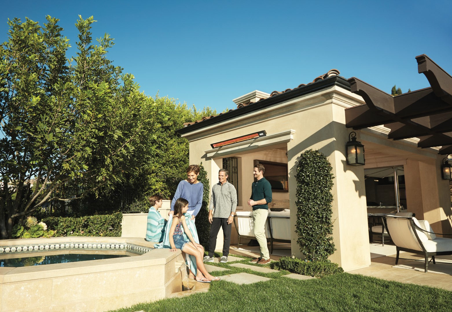a-family-and-some-friends-enjoyng-the-outdoor-heated-by-a-single-wall-mounted-SL-Infratech-heater